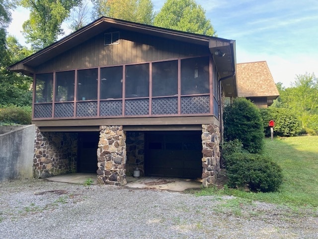 view of front of home with a sunroom