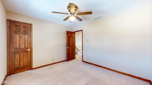 empty room with light carpet and ceiling fan