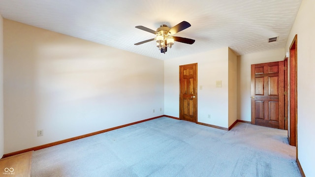 unfurnished bedroom with ceiling fan and light colored carpet