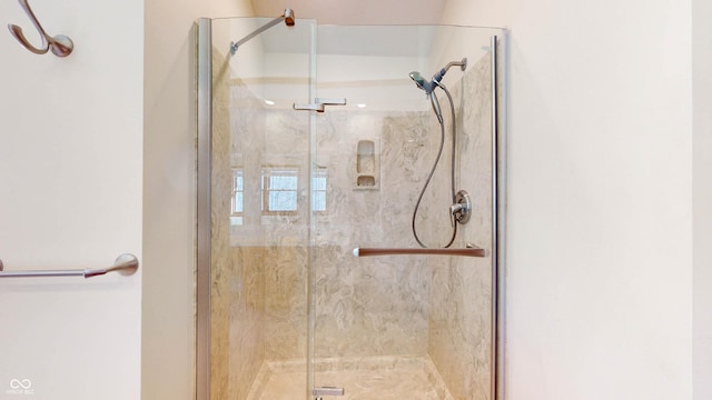 bathroom with a shower with shower door