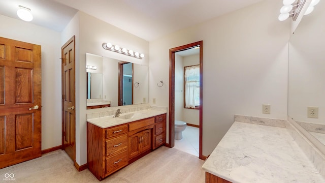 bathroom featuring vanity, toilet, and tile patterned flooring