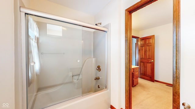 bathroom with bath / shower combo with glass door