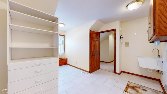 spacious closet featuring sink