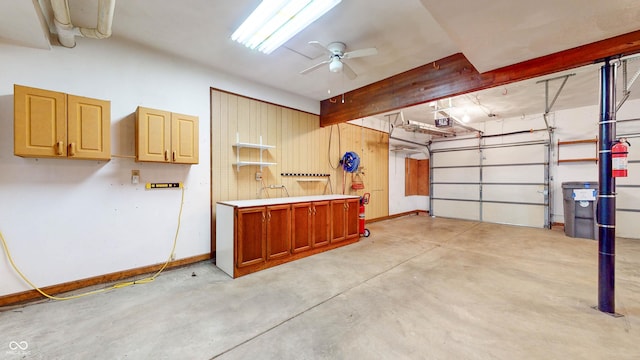 garage with ceiling fan and a garage door opener