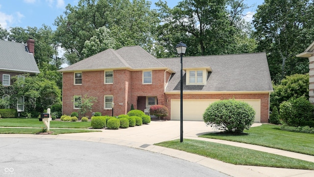 colonial house featuring a garage and a front yard