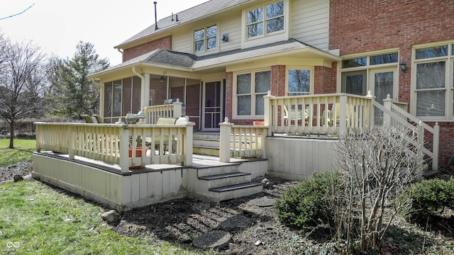 rear view of house featuring a deck and a sunroom