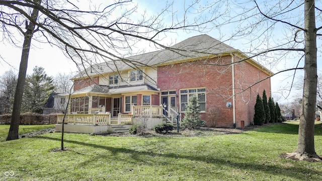 view of front of house with a deck and a front yard