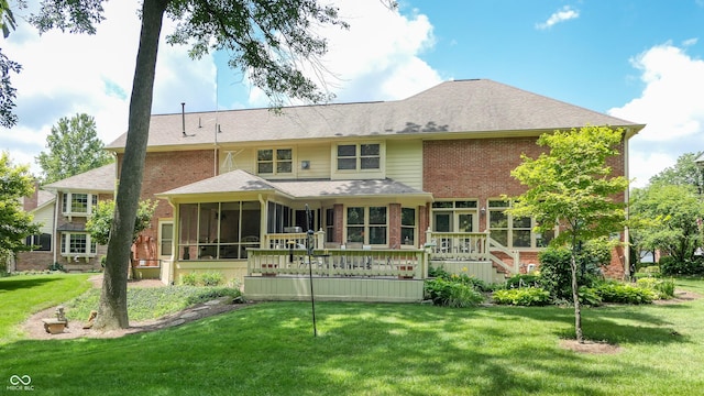 back of house featuring a wooden deck, a sunroom, and a yard