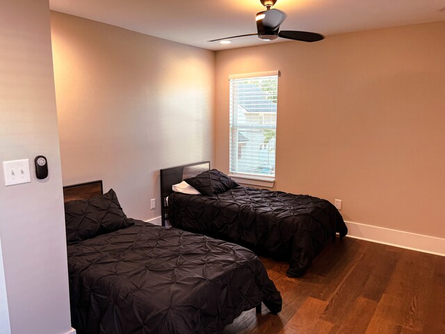 bedroom featuring dark hardwood / wood-style flooring and ceiling fan