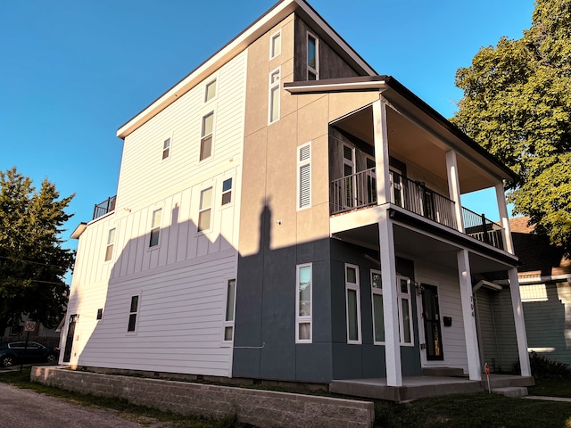 view of side of property with a balcony