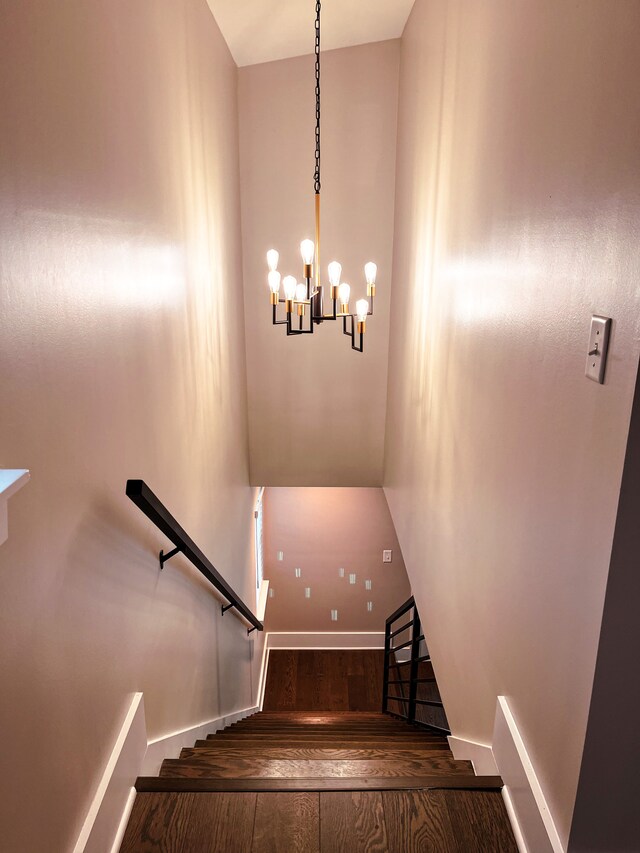 stairway featuring a chandelier and hardwood / wood-style flooring