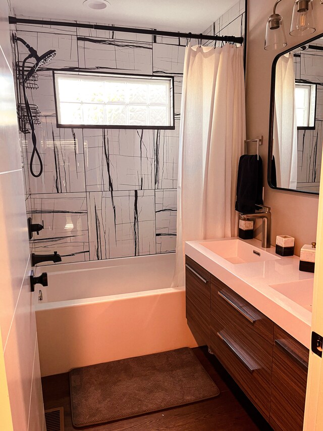 bathroom featuring oversized vanity and shower / bath combo with shower curtain