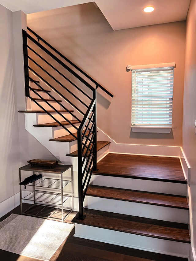 stairs with dark hardwood / wood-style floors