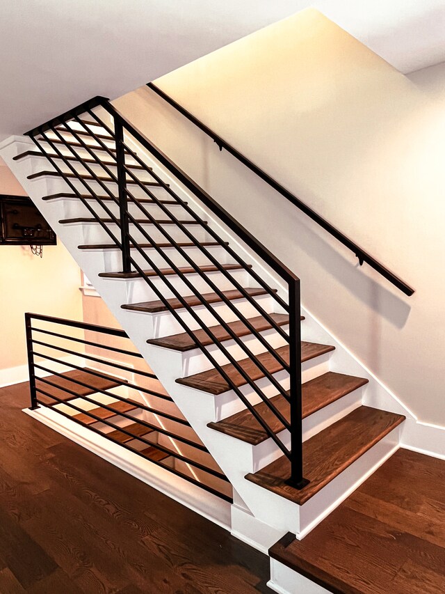 stairs featuring wood-type flooring