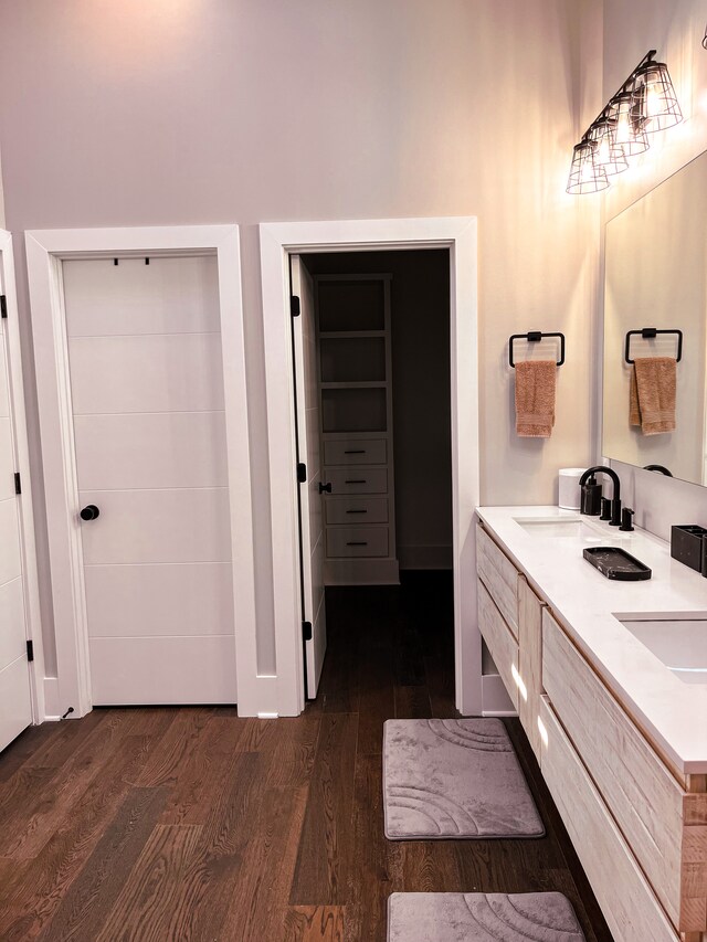 bathroom featuring hardwood / wood-style floors and double vanity