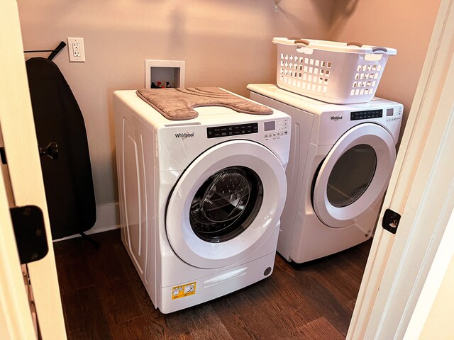 laundry area featuring washing machine and dryer, dark wood-type flooring, and washer hookup