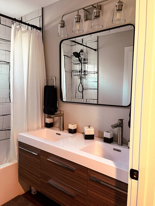 bathroom featuring large vanity, shower / bath combo, and double sink