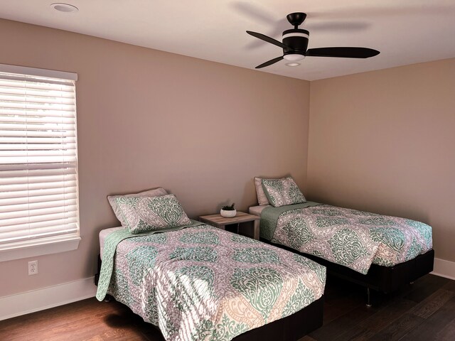 bedroom featuring ceiling fan and dark wood-type flooring