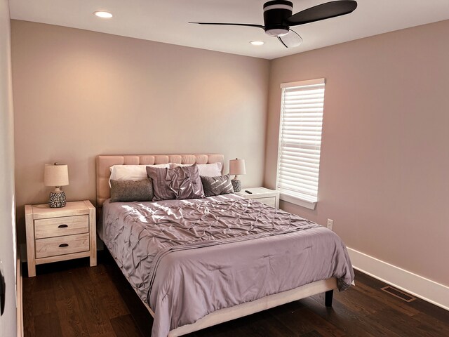 bedroom with ceiling fan and dark wood-type flooring