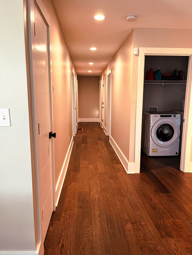 hall featuring washer / clothes dryer and dark wood-type flooring