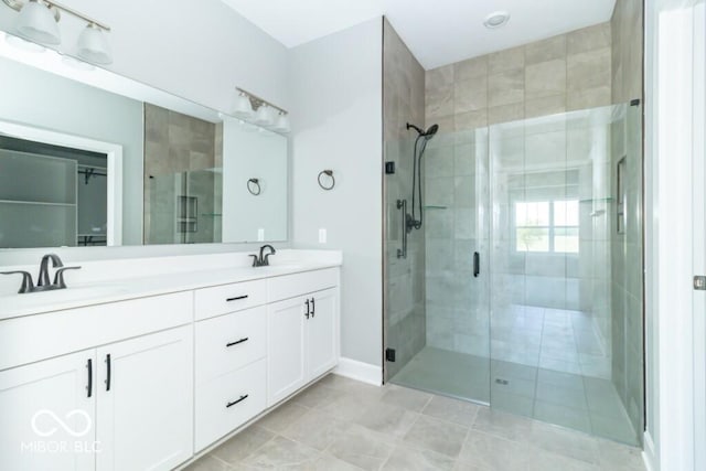 bathroom featuring tile flooring, a shower with shower door, oversized vanity, and double sink