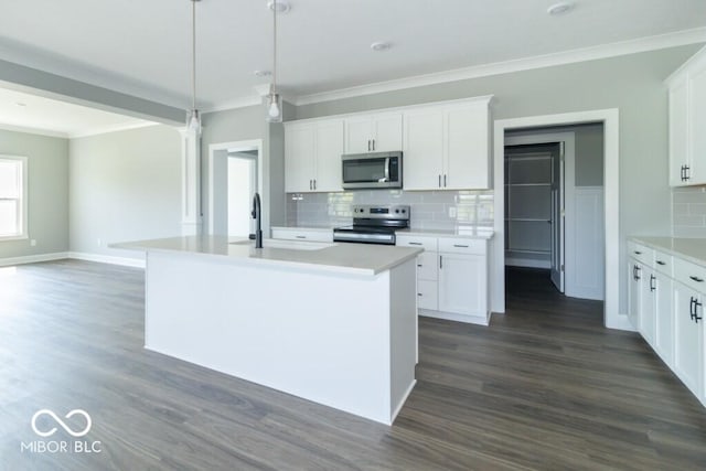 kitchen featuring stainless steel appliances, an island with sink, and white cabinets