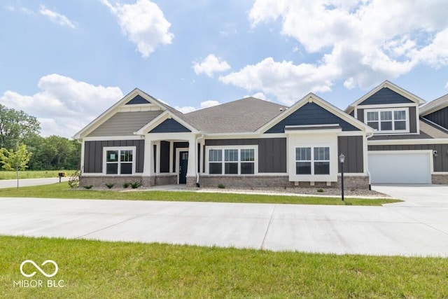 craftsman inspired home with a garage and a front yard