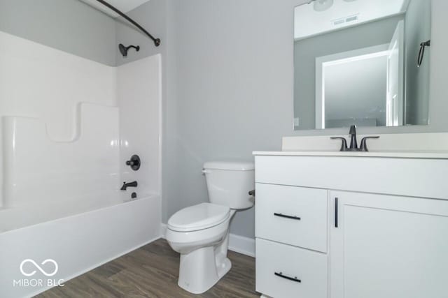 full bathroom with vanity, toilet, hardwood / wood-style floors, and  shower combination