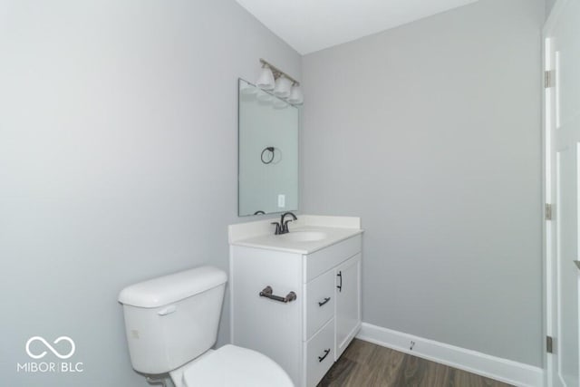 bathroom with vanity, hardwood / wood-style flooring, and toilet