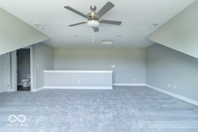 additional living space featuring ceiling fan, lofted ceiling, and carpet flooring