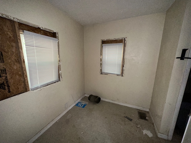 spare room with a textured ceiling