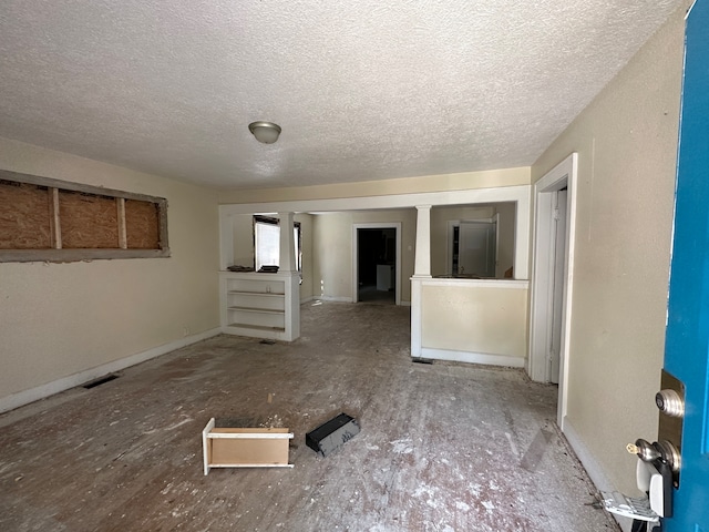 spare room with a textured ceiling