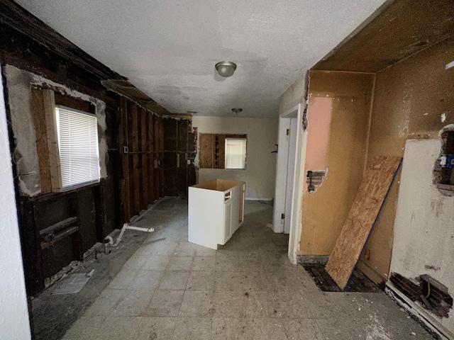 corridor with a textured ceiling