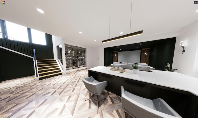 interior space with light parquet floors and a breakfast bar