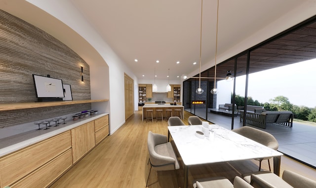 dining area featuring light hardwood / wood-style flooring and a wall of windows