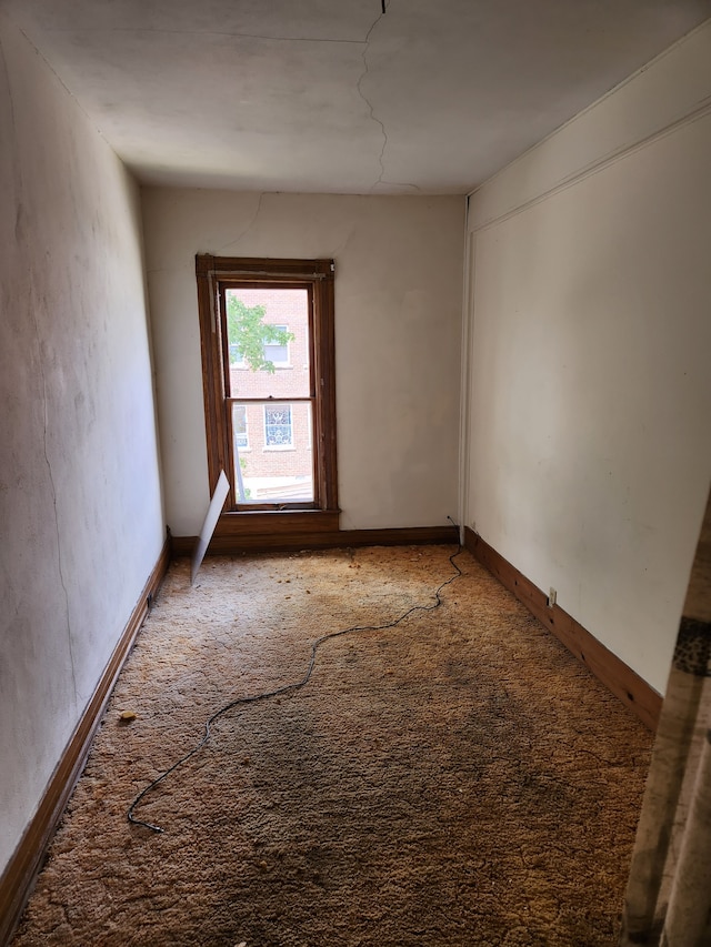 unfurnished room with dark carpet