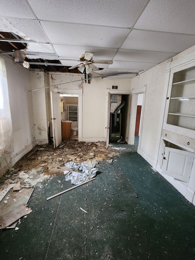 interior space featuring ceiling fan and a paneled ceiling