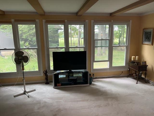 living room with beam ceiling