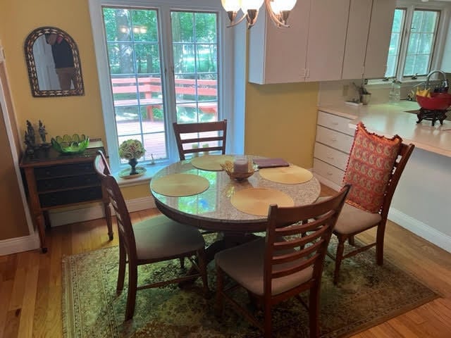 dining area with a notable chandelier and light wood-type flooring