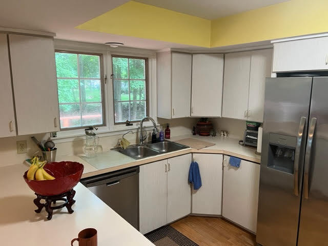 kitchen featuring light wood-type flooring, white cabinetry, appliances with stainless steel finishes, and sink