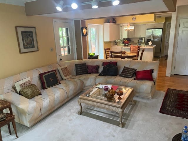 living room with a chandelier and light hardwood / wood-style floors