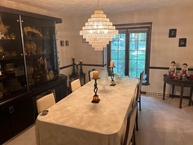 dining area featuring a textured ceiling and an inviting chandelier