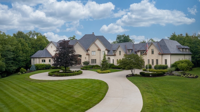 french country style house with a front yard