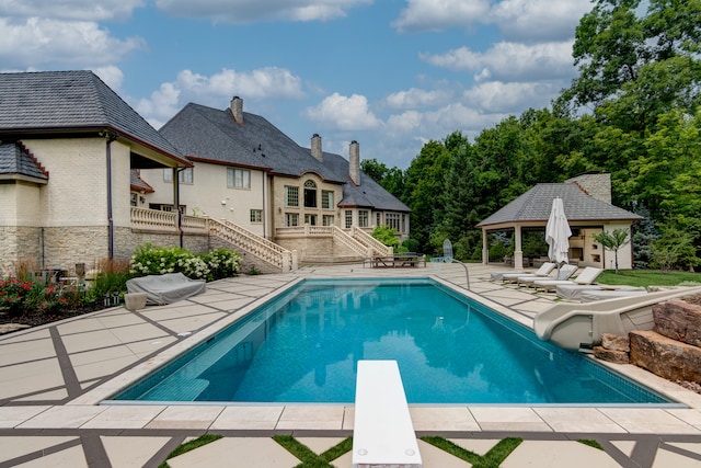 view of pool featuring a gazebo, a diving board, and a patio