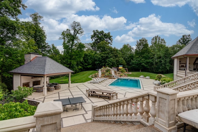 view of pool with a lawn, a patio, and a gazebo