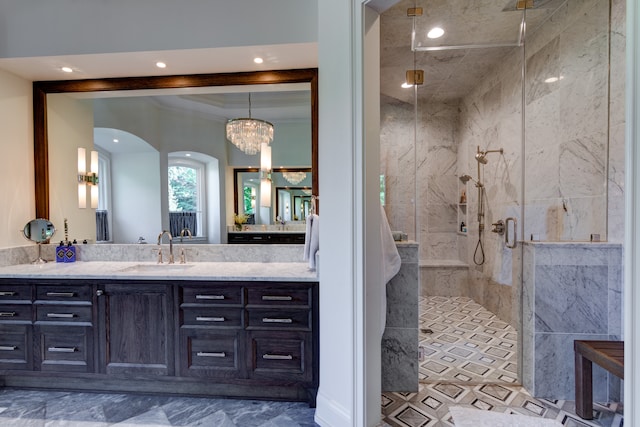 bathroom with vanity, walk in shower, tile floors, a chandelier, and crown molding