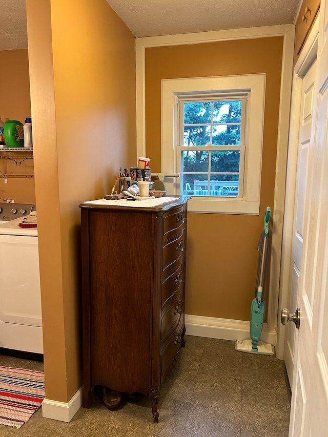 bathroom featuring tile floors, washer / clothes dryer, vanity, and a textured ceiling