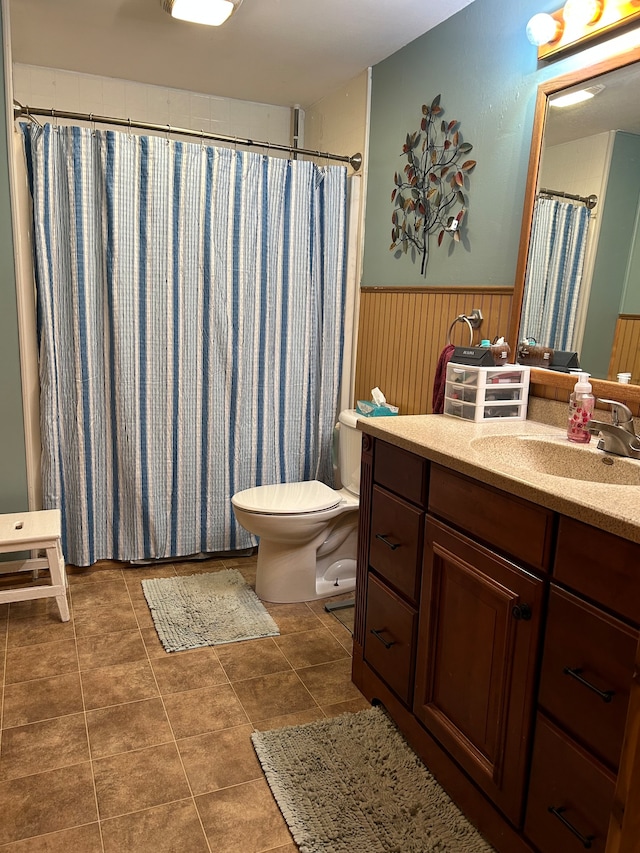 bathroom featuring tile floors, toilet, and vanity