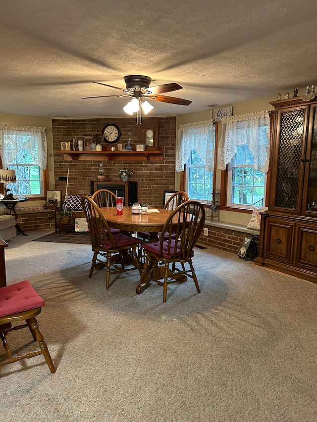 dining room featuring plenty of natural light, a brick fireplace, and carpet