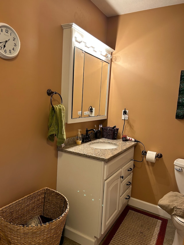 bathroom featuring toilet and vanity